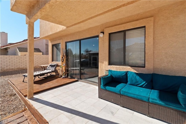 view of patio with fence and a wooden deck