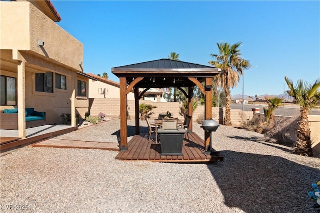 view of yard featuring a fenced backyard, a deck, and a gazebo