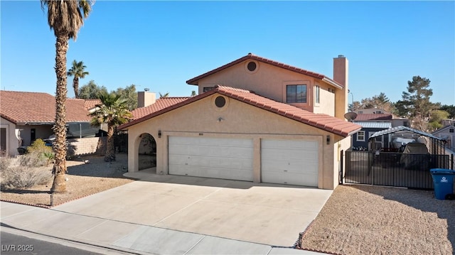 mediterranean / spanish home with driveway, a tile roof, a chimney, and stucco siding