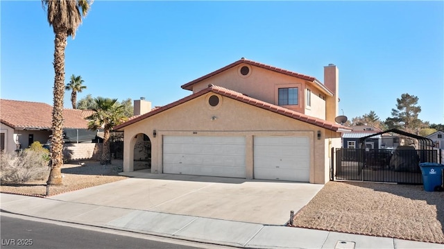 mediterranean / spanish home with a chimney, stucco siding, fence, driveway, and a tiled roof