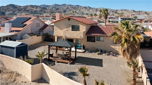 exterior space with a residential view, a mountain view, and a gazebo