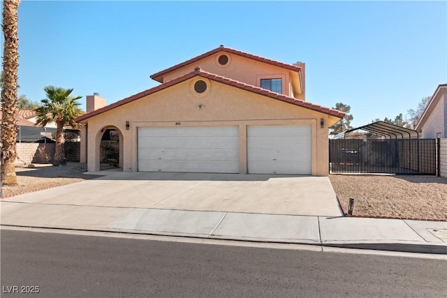 mediterranean / spanish-style home with a garage, a gate, driveway, and stucco siding