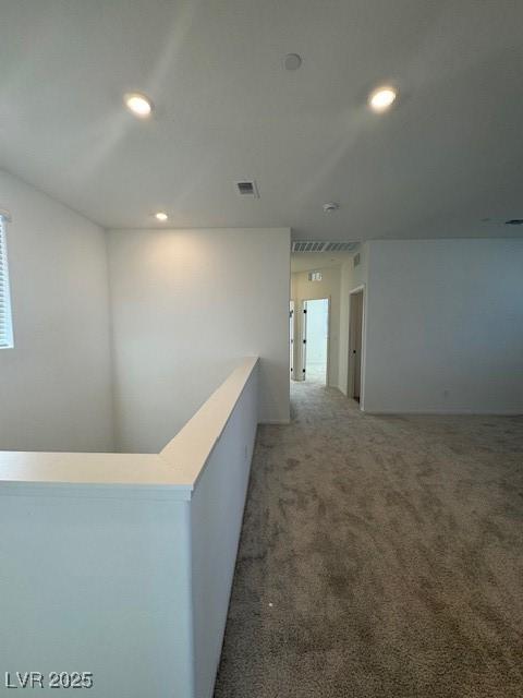 hallway featuring carpet floors, recessed lighting, and visible vents