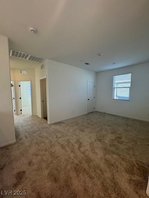 unfurnished room featuring carpet floors and visible vents