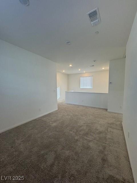 carpeted spare room with baseboards, visible vents, and recessed lighting