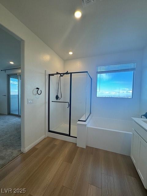 full bath with recessed lighting, vanity, a shower stall, wood finished floors, and a bath