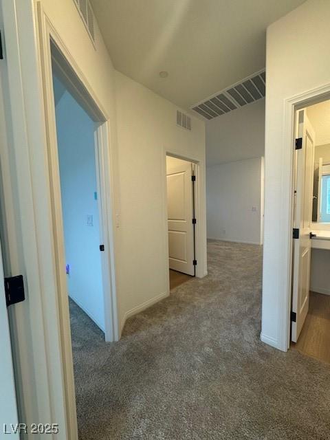 corridor with carpet and visible vents