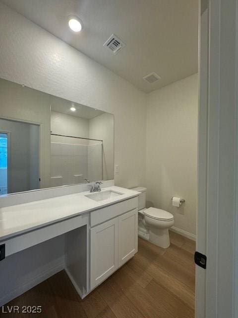 full bathroom featuring recessed lighting, visible vents, toilet, vanity, and wood finished floors