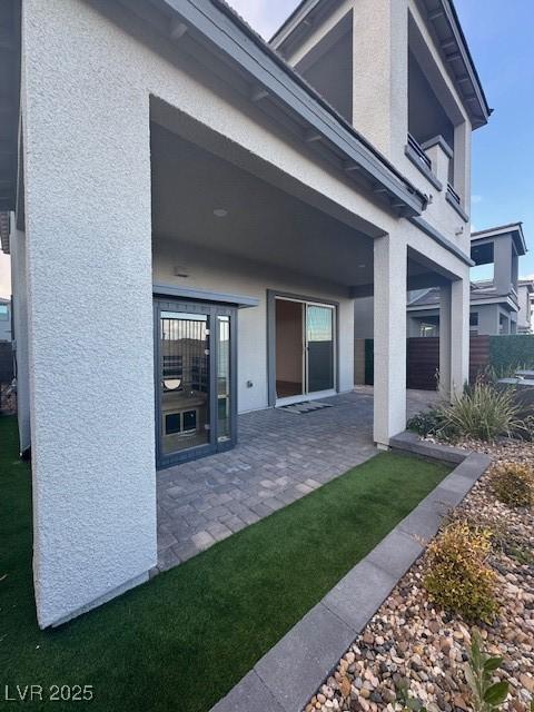 back of house featuring a patio area, fence, and stucco siding