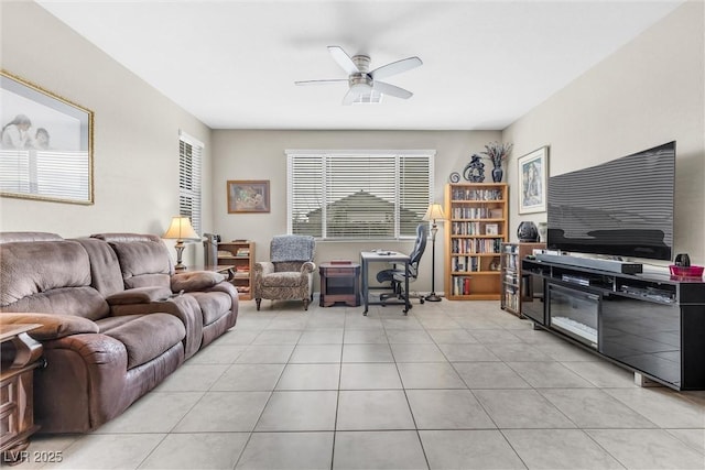 living area featuring ceiling fan and light tile patterned floors