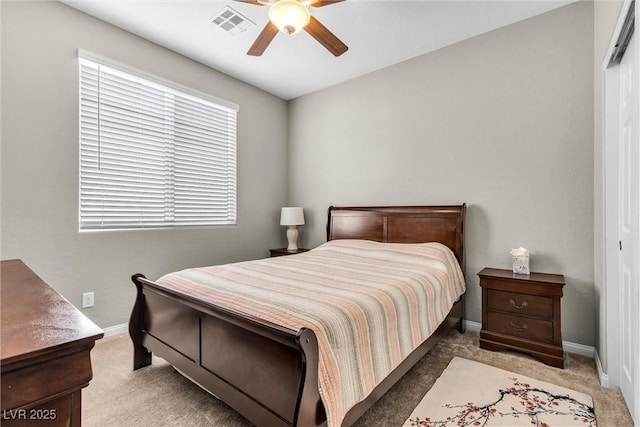 bedroom with light carpet, baseboards, visible vents, and a ceiling fan