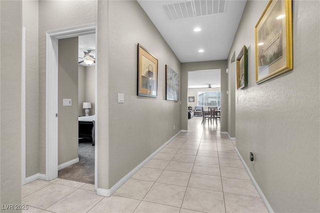 hallway with recessed lighting, baseboards, visible vents, and light tile patterned flooring