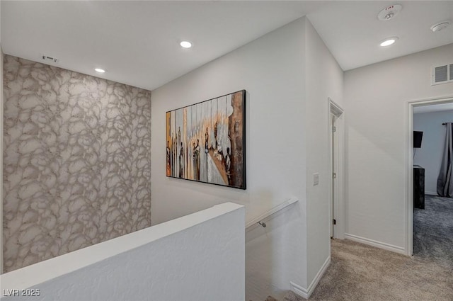 corridor featuring visible vents, carpet floors, an upstairs landing, and recessed lighting