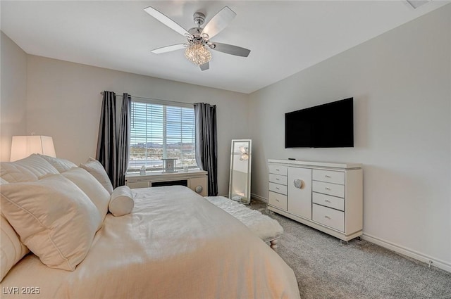 bedroom with light carpet, baseboards, and a ceiling fan