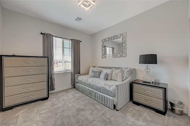 carpeted bedroom featuring visible vents and baseboards