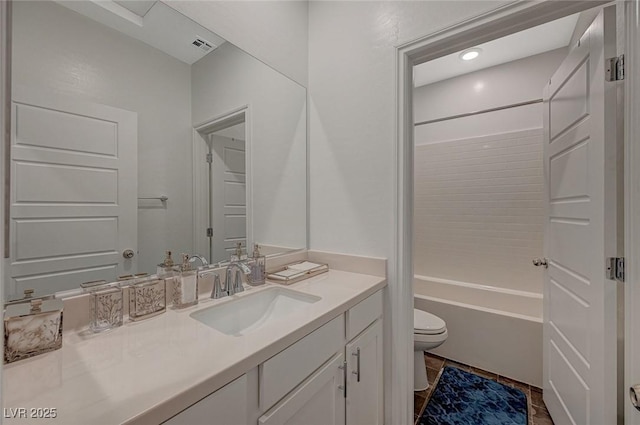 bathroom featuring bathtub / shower combination, vanity, and toilet