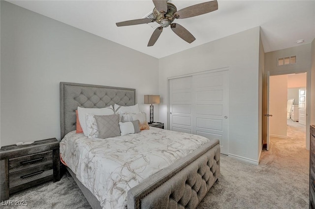 bedroom with a closet, visible vents, a ceiling fan, light carpet, and baseboards