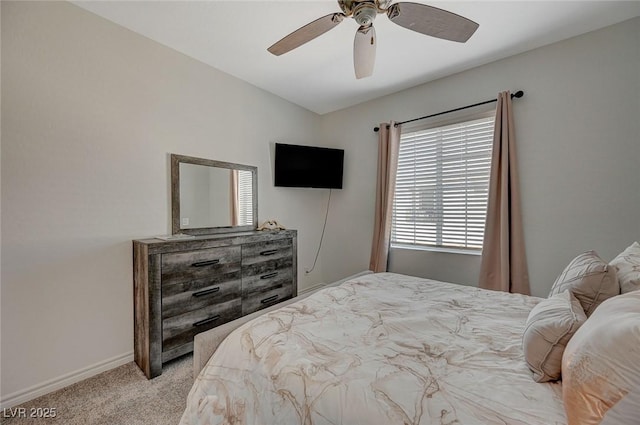 carpeted bedroom with a ceiling fan and baseboards