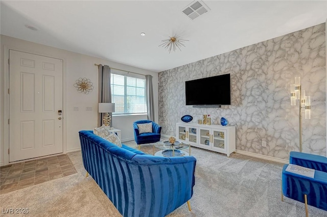 living room with carpet, visible vents, and baseboards