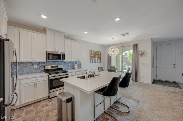 kitchen featuring stainless steel appliances, white cabinets, and a sink