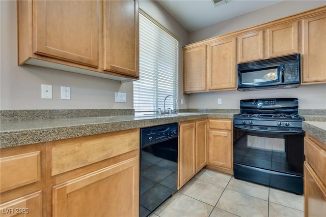 kitchen with a sink, black appliances, and light tile patterned floors