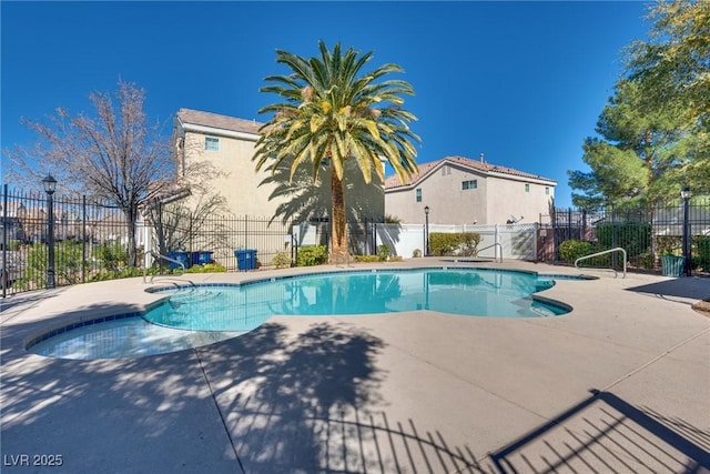 view of swimming pool featuring a patio area, fence, and a fenced in pool