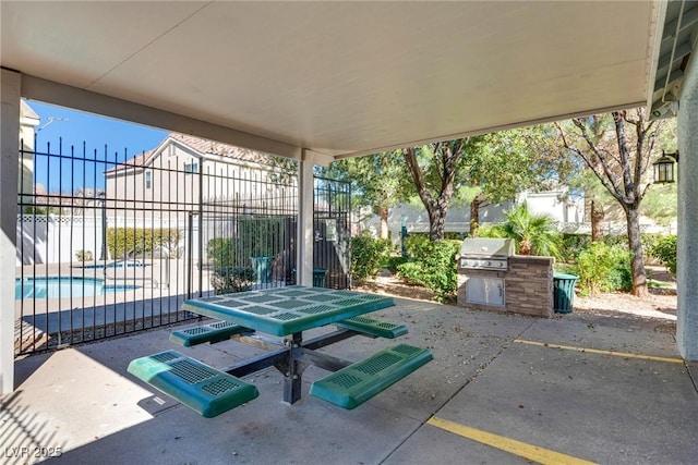 view of patio / terrace featuring fence, grilling area, and exterior kitchen