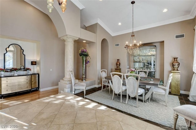 dining room with decorative columns, visible vents, arched walkways, and baseboards