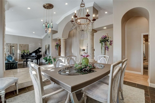 dining area featuring arched walkways, recessed lighting, crown molding, baseboards, and ornate columns