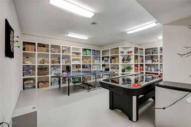 recreation room with finished concrete floors and visible vents