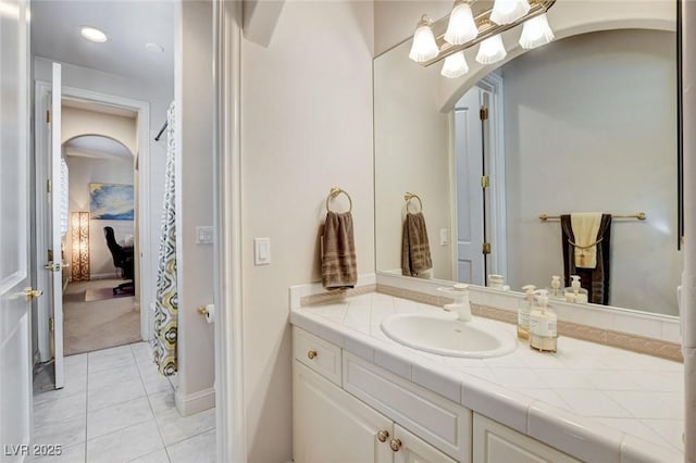 ensuite bathroom with vanity, ensuite bath, and tile patterned floors