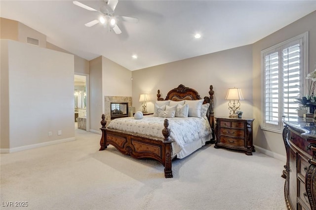 bedroom with light colored carpet, lofted ceiling, a multi sided fireplace, and baseboards