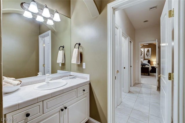 ensuite bathroom featuring ensuite bath, tile patterned flooring, visible vents, and vanity