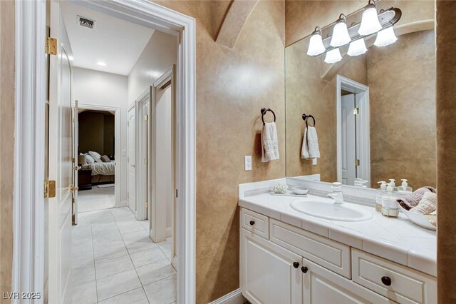 ensuite bathroom featuring tile patterned flooring, vanity, visible vents, and ensuite bathroom