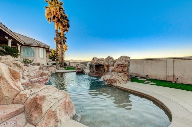 view of swimming pool with fence and a fenced in pool