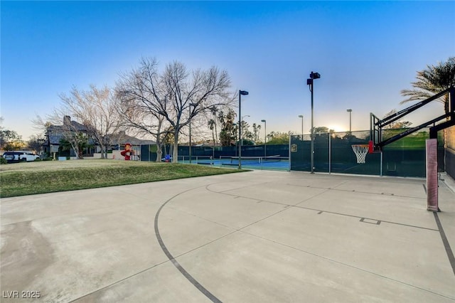 view of basketball court with a tennis court, community basketball court, and fence