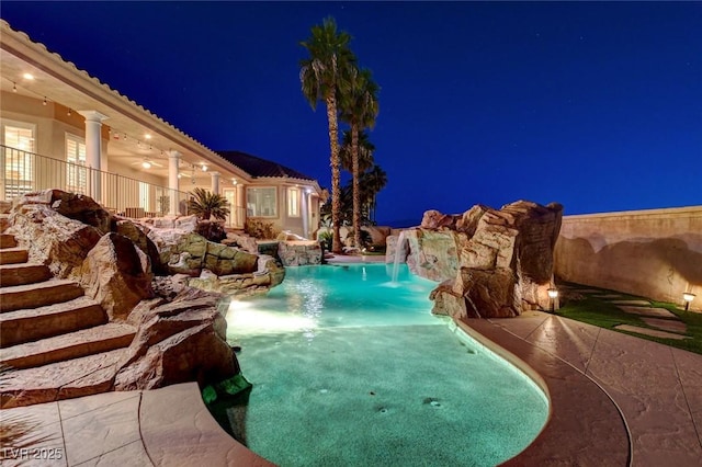 pool at night with an outdoor pool