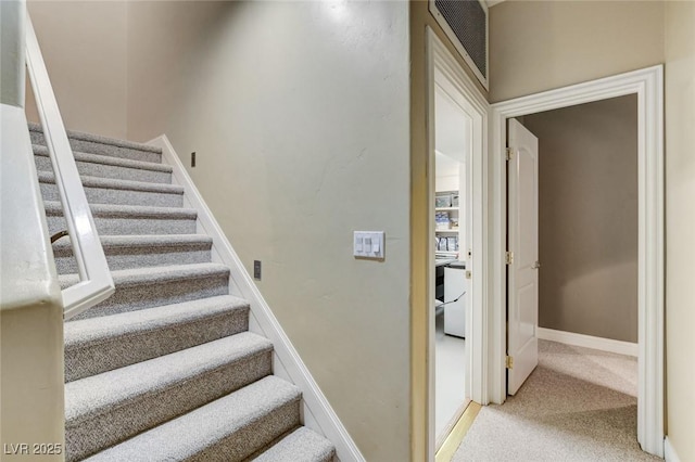 staircase featuring carpet, visible vents, and baseboards