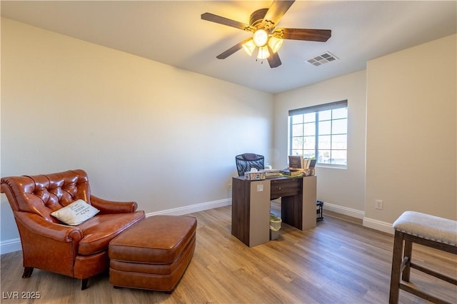 office area with visible vents, ceiling fan, baseboards, and wood finished floors