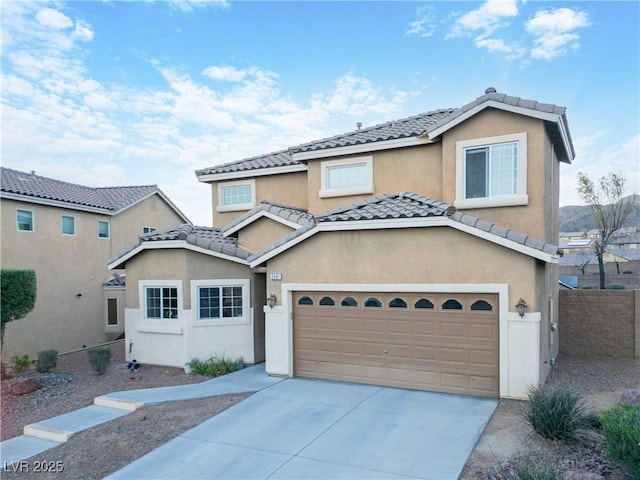 view of front of property featuring concrete driveway, a tile roof, and stucco siding