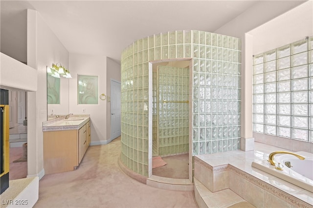 bathroom with walk in shower, vanity, and a bath