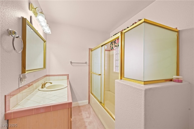 full bath with combined bath / shower with glass door, vanity, and baseboards