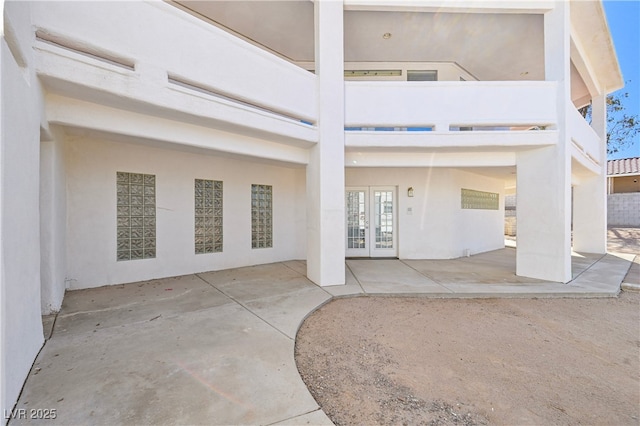 exterior space featuring a patio, french doors, and stucco siding