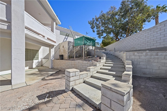 view of patio / terrace featuring a fenced backyard and stairway