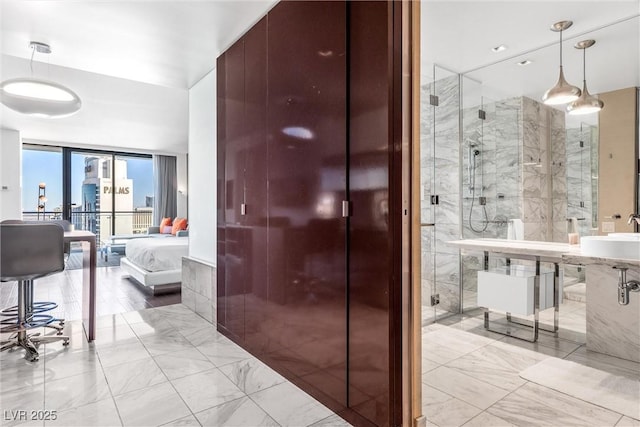 full bathroom featuring connected bathroom, a stall shower, marble look tiles, and a wall of windows