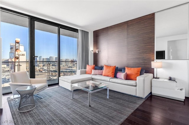 living room with expansive windows, hardwood / wood-style floors, and a city view