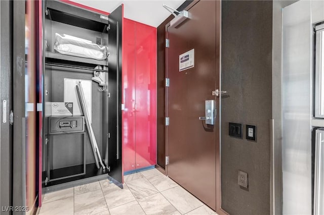 kitchen featuring light marble finish floors and elevator