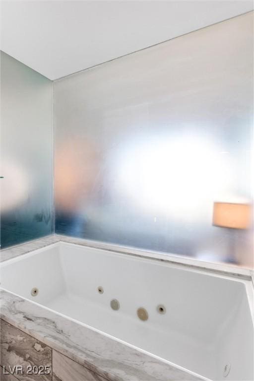 bathroom featuring a tub with jets