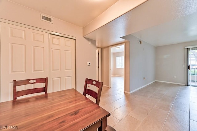 dining area featuring visible vents, baseboards, and light tile patterned floors