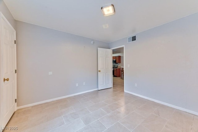 interior space featuring visible vents, baseboards, and light tile patterned floors